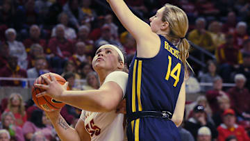 Iowa State Cyclones center Audi Crooks (55) looks for a shot around West Virginia Mountaineers Forward Kylee Blacksten (14) during the first quarter in the Big-12 conference matchup at Hilton Coliseum on Wednesday, Jan. 10, 2024, in Ames, Iowa.