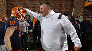 Oct 8, 2022; Champaign, Illinois, USA;  Illinois Fighting Illini head coach Bret Bielema celebrates with player Kody Case (87) after defeating the Iowa Hawkeyes at Memorial Stadium. 