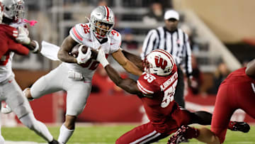 Oct 28, 2023; Madison, Wisconsin, USA; Wisconsin Badgers linebacker Maema Njongmeta (55) attempts to tackle Ohio State Buckeyes running back TreVeyon Henderson (32) during the second half of the NCAA football game at Camp Randall Stadium.