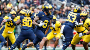 Blue Team wide receiver Tyler Morris (8) runs for first down against Maize Team during the spring game at Michigan Stadium in Ann Arbor on Saturday, April 20, 2024.
