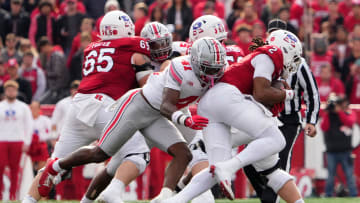Nov 4, 2023; Piscataway, New Jersey, USA; Ohio State Buckeyes safety Josh Proctor (41) pressures Rutgers Scarlet Knights quarterback Gavin Wimsatt (2) during the first half of the NCAA football game at SHI Stadium.