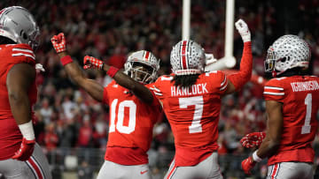 Nov 18, 2023; Columbus, Ohio, USA; Ohio State Buckeyes cornerback Jordan Hancock (7) and cornerback Denzel Burke (10) celebrate an interception by Hancock during the second half of the NCAA football game against the Minnesota Golden Gophers at Ohio Stadium. Ohio State won 37-3.