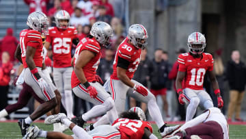 Nov 18, 2023; Columbus, Ohio, USA; Ohio State Buckeyes linebacker Steele Chambers (22) tackles Minnesota Golden Gophers quarterback Athan Kaliakmanis (8) during the first half of the NCAA football game at Ohio Stadium.