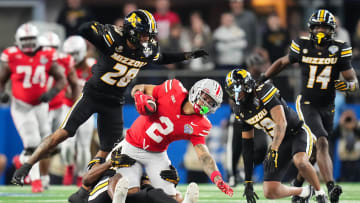 Dec 29, 2023; Arlington, Texas, USA; Missouri Tigers defensive back Jaylon Carlies (1) tackles Ohio State Buckeyes wide receiver Emeka Egbuka (2) during the fourth quarter of the Goodyear Cotton Bowl Classic at AT&T Stadium. Ohio State lost 14-3.