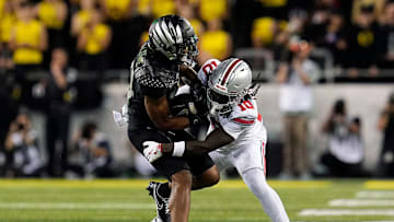 Oct 12, 2024; Eugene, Oregon, USA; Ohio State Buckeyes cornerback Denzel Burke (10) makes a tackle on Oregon Ducks wide receiver Justius Lowe (14) after a catch in the second half during the NCAA football game at Autzen Stadium