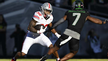 Oct 12, 2024; Eugene, Oregon, USA; Ohio State Buckeyes running back TreVeyon Henderson (32)   runs with the ball during the first half against Oregon Ducks defensive back Jabbar Muhammad (7) at Autzen Stadium. Mandatory Credit: Troy Wayrynen-Imagn Images