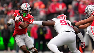 Ohio State Buckeyes running back Quinshon Judkins (1) runs around Indiana Hoosiers defensive lineman Tyrique Tucker (95) during the second half of the NCAA football game at Ohio Stadium in Columbus on Saturday, Nov. 23, 2024. Ohio State won 38-15.