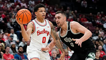 Ohio State Buckeyes guard John Mobley Jr. (0) passes over Green Bay Phoenix guard Foster Wonders (0) during the first half of the NCAA men's basketball game at Value City Arena in Columbus on Monday, Nov. 25, 2024.