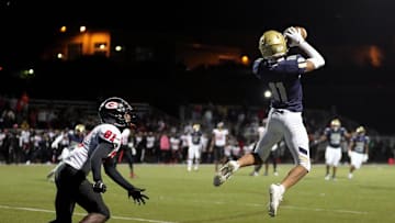 Hoban defensive back Elbert Hill IV, right, picks off a pass intended for Glenville wide receiver Donald Overby during the second half of a high school football game, Friday, Oct. 6, 2023, in Akron, Ohio.