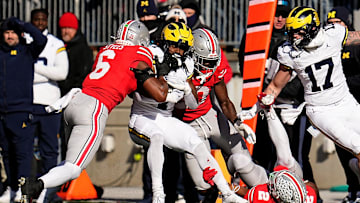Ohio State Buckeyes safety Sonny Styles (6) tackles Michigan Wolverines running back Donovan Edwards (7) during the first half of the NCAA football game at Ohio Stadium in Columbus on Saturday, Nov. 30, 2024.