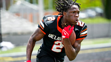 Delaware Hayes’s Favour Akih (2) runs the ball during the college football showcase at the Delaware Hayes High School on Wednesday, May 7, 2025 in Delaware, Ohio.