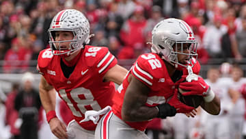 Ohio State Buckeyes quarterback Will Howard (18) hands off to running back TreVeyon Henderson (32) during the first half of the NCAA football game against the Indiana Hoosiers at Ohio Stadium in Columbus on Saturday, Nov. 23, 2024.