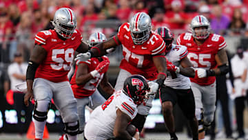 Sep 16, 2023; Columbus, Ohio, USA; Ohio State Buckeyes offensive lineman Tegra Tshabola (77) goes to tackle Western Kentucky Hilltoppers defensive tackle Hosea Wheeler (98) during the NCAA football game at Ohio Stadium. Ohio State won 63-10.