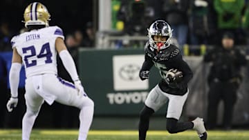 Nov 30, 2024; Eugene, Oregon, USA; Oregon Ducks wide receiver Tez Johnson (15) catches a pass during the second half against Washington Huskies safety Makell Esteen (24) at Autzen Stadium. Mandatory Credit: Troy Wayrynen-Imagn Images
