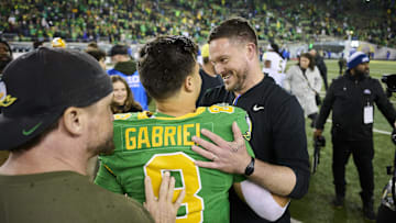 Nov 9, 2024; Eugene, Oregon, USA; Oregon Ducks head coach Dan Lanning celebrates with quarterback Dillon Gabriel (8) after beating the Maryland Terrapins at Autzen Stadium.