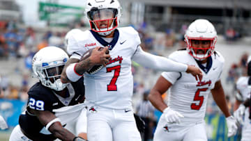 Liberty quarterback Kaidon Salter (7) runs the ball into the end zone for a touchdown as Middle Tennessee cornerback Tyrell Raby (29) tries to stop him and Liberty wide receiver Elijah Canion (5) looks on during the Salute to Veterans & Armed Forces game at MTSU on Saturday, Nov. 9, 2024.