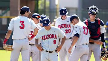 May 25, 2022; Scottsdale, Arizona, USA; Arizona Wildcats head coach Chip Hale (8) returns to the dugout after a meeting with pitcher Dawson Netz (27) against the Oregon Ducks in the third inning during the Pac-12 Baseball Tournament at Scottsdale Stadium.

Ncaa Baseball Arizona At Oregon