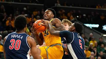 Feb 17, 2025; Waco, Texas, USA; Baylor Bears guard Jalen Celestine (32) is fouled driving to the basket by Arizona Wildcats guard KJ Lewis (5) during the first half at Paul and Alejandra Foster Pavilion. Mandatory Credit: Chris Jones-Imagn Images