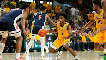 Feb 17, 2025; Waco, Texas, USA;  Baylor Bears guard Robert Wright III (1) controls the ball as Arizona Wildcats forward Tobe Awaka (30) defends during the first half at Paul and Alejandra Foster Pavilion. Mandatory Credit: Chris Jones-Imagn Images