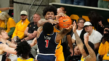 Feb 17, 2025; Waco, Texas, USA;  Arizona Wildcats guard Caleb Love (1) has his shot blocked by Baylor Bears forward Norchad Omier (15) during the second half at Paul and Alejandra Foster Pavilion. Mandatory Credit: Chris Jones-Imagn Images