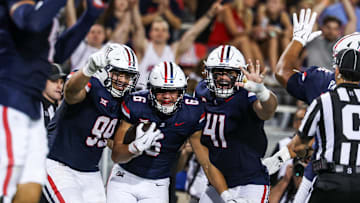 Aug 30, 2025; Tucson, Arizona, USA; Arizona Wildcats defensive lineman Mays Pese (99), linebacker Taye Brown (6), and defensive lineman Julian Saviinaea (41) all celebrate after they intercept the ball from the Hawaii Rainbow Warriors during the third quarter of the game at Arizona Stadium. Mandatory Credit: Aryanna Frank-Imagn Images