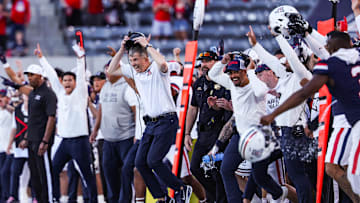 Nov 8, 2025; Tucson, Arizona, USA; Arizona Wildcats head coach Brent Brennan takes off his headset as they secure the win against the Kansas Jayhawks at the end of the fourth quarter of the game at Arizona Stadium. Mandatory Credit: Aryanna Frank-Imagn Images