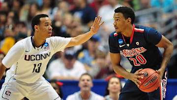 Mar 26, 2011; Anaheim, CA, USA; Arizona Wildcats guard Jordin Mayes (20) controls the ball against the defense of Connecticut Huskies guard Shabazz Napier (13) during the finals of the west regional of the 2011 NCAA men's basketball tournament at the Honda Center. Mandatory Credit: Gary A. Vasquez-Imagn Images