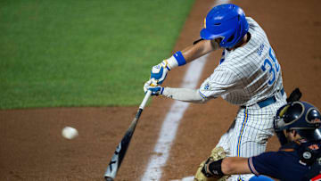 UCLA Bruins outfielder swings at the ball.