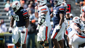 Auburn Tigers defensive lineman Marcus Harris (50) celebrates after making a stop in the backfield during the A-Day spring practice at Jordan-Hare Stadium in Auburn, Ala., on Saturday, April 9, 2022.