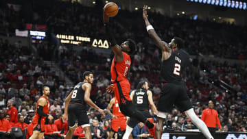 Apr 12, 2024; Portland, Oregon, USA; Houston Rockets guard Aaron Holiday (0) scores a basket on a layup during the first half against Portland Trail Blazers center Deandre Ayton (2) at Moda Center. Mandatory Credit: Troy Wayrynen-USA TODAY Sports