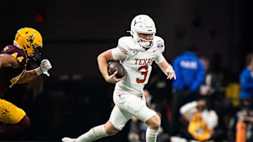 Texas Longhorns quarterback Quinn Ewers (3) runs the ball as Arizona State Sun Devils linebacker Keyshaun Elliott (44) chases in the second quarter as the Texas Longhorns play the Arizona State Sun Devils in the Peach Bowl College Football Playoff quarterfinal at Mercedes-Benz Stadium in Atlanta, Georgia, Jan. 1, 2025.