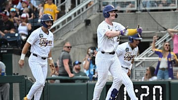 Jun 16, 2025; Omaha, Neb, USA;  LSU Tigers first baseman Jared Jones (22) celebrates with shortstop Steven Milam (4) and right fielder Jake Brown (7) after hitting a three run home run against the UCLA Bruins at Charles Schwab Field. 