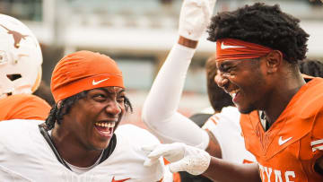 Texas Longhorns running back Ky Woods (29) celebrates with teammate defensive back Jelani McDonald (25).
