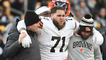 Jan 8, 2023; Pittsburgh, Pennsylvania, USA;  Injured Cleveland Browns tackle Jedrick Wills Jr. (71) is helped off the field in a game against the Pittsburgh Steelers during the fourth quarter at Acrisure Stadium. Mandatory Credit: Philip G. Pavely-Imagn Images