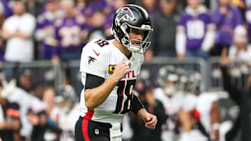 Dec 8, 2024; Minneapolis, Minnesota, USA; Atlanta Falcons quarterback Kirk Cousins (18) celebrates running back Tyler Allgeier's (25) touchdown against the Minnesota Vikings during the first quarter at U.S. Bank Stadium. Mandatory Credit: Matt Krohn-Imagn Images