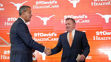 University of Texas baseball coach Jim Schlossnagle, right, is introduced by Athletic Director Chris Del Conte at his introductory news conference at the Frank Denius Family University Hall of Fame Wednesday June 26, 2024.