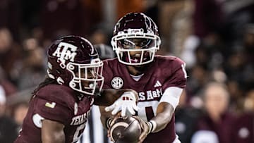 Nov 30, 2024; College Station, Texas, USA; Texas A&M Aggies quarterback Marcel Reed (10) hands the ball off to running back Amari Daniels (5) in the first quarter of the Lone Star Showdown against the Texas Longhorns at Kyle Field. Mandatory Credit: Sara Diggins/USA TODAY Network via Imagn Images