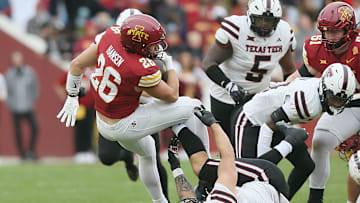 Iowa State running back Carson Hansen (26) battles for few yards as he gets tackled by Texas Tech's Jacob Rodriguez (10) during their game at Jack Trice Stadium on Saturday, Nov. 2, 2024, in Ames, Iowa.
