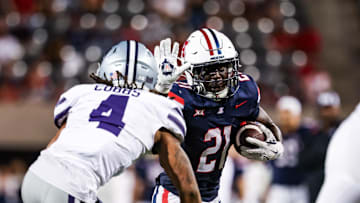 Sep 12, 2025; Tucson, Arizona, USA; Arizona Wildcats running back Ismail Mahdi (21) runs the ball while Kansas State Wildcats safety Daniel Cobbs (4) defends during the fourth quarter at Arizona Stadium. Mandatory Credit: Aryanna Frank-Imagn Images