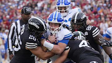 Iowa State Cyclones' linebacker Caleb Bacon (26) and linebacker Kooper Ebel (47) takes down BYU Cougars quarterback Bear Bachmeier (47) during the first quarter at Jack Trice Stadium on Oct. 25, 2025, in Ames, Iowa.