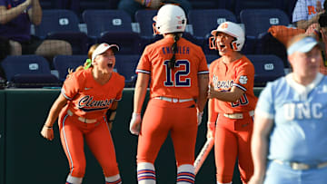 Clemson Jamison Brockenbrough (9), left, and Sam Minish (20), right, greet teammate Julia Knowler (12) scoring against University of North Carolina during the bottom of the first inning at McWhorter Stadium in Clemson Friday, March 14, 2025.