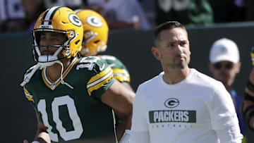 Sep 29, 2024; Green Bay, Wisconsin, USA;  Green Bay Packers quarterback Jordan Love (10) and head coach Matt LaFleur walk onto the field before the game against the Minnesota Vikings at Lambeau Field. Mandatory Credit: William Glasheen/USA TODAY Network via Imagn Images