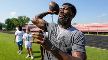 Nate Hobbs works with aspiring young football players at the camp that bears his name. The camp was held at Waggener High School on Saturday, July 13, 2024
