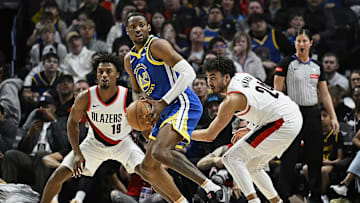 Apr 11, 2024; Portland, Oregon, USA; Golden State Warriors forward Jonathan Kuminga (00) looks to pass during the second half against Portland Trail Blazers guard Ashton Hagans (19), and forward Justin Minaya (24) at Moda Center. Mandatory Credit: Troy Wayrynen-Imagn Images