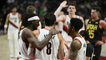 Oct 18, 2024; Portland, Oregon, USA; Portland Trail Blazers forward Deni Avdija (8) is helped up during the second half by teammates Portland Trail Blazers forward Jerami Grant (9), left, and guard Anfernee Simons (1) against the Utah Jazz at Moda Center. Mandatory Credit: Troy Wayrynen-Imagn Images