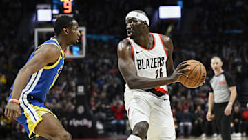 Apr 11, 2024; Portland, Oregon, USA; Portland Trail Blazers center Duop Reath (26) looks to pass the ball during the second half against Golden State Warriors forward Jonathan Kuminga (00) at Moda Center. Mandatory Credit: Troy Wayrynen-Imagn Images