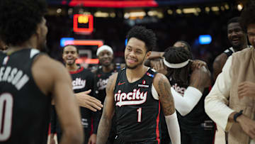 Dec 19, 2024; Portland, Oregon, USA; Portland Trail Blazers guard Anfernee Simons (1) celebrates with teammates after scoring the game winning shot against the Denver Nuggets at Moda Center. Mandatory Credit: Troy Wayrynen-Imagn Images