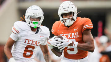 Texas Orange team wide receiver Ryan Wingo (5) carries the ball in for a touchdown as Texas White team defensive back Kobe Black (6) chases in the second quarter of the Longhorns' spring Orange and White game at Darrell K Royal Texas Memorial Stadium in Austin, Texas, April 20, 2024.