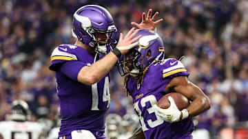 Dec 8, 2024; Minneapolis, Minnesota, USA; Minnesota Vikings running back Aaron Jones (33) celebrates his running touchdown with quarterback Sam Darnold (14) during the fourth quarter against the Atlanta Falcons at U.S. Bank Stadium. Mandatory Credit: Matt Krohn-Imagn Images