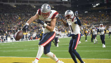 New England Patriots tight end Hunter Henry (85) spikes the football after a touchdown reception.